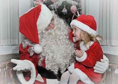 Little girl with Santa Claus.