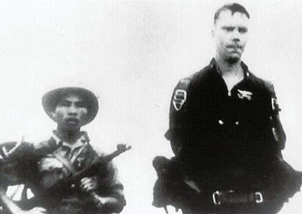 POW Robert Harper Shumaker standing with one of his captors by his side