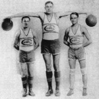 photo of Charles “Horse” Gillium with outstretched arms palming a basketball in each hand