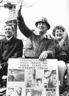 Chuck Tanner waving. He is holding a poster that says, Congratulations Chuck Tanner for Word Champion Pittsburgh Pirates.